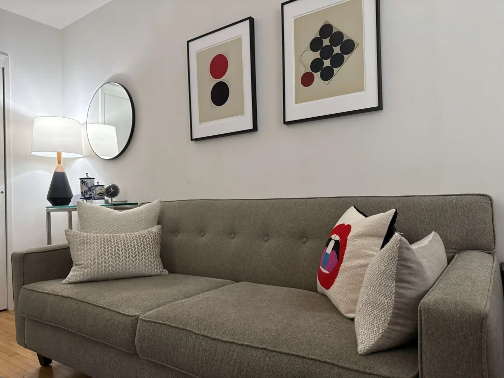 Comfortable therapy room with sofa, cushions, and framed art.
