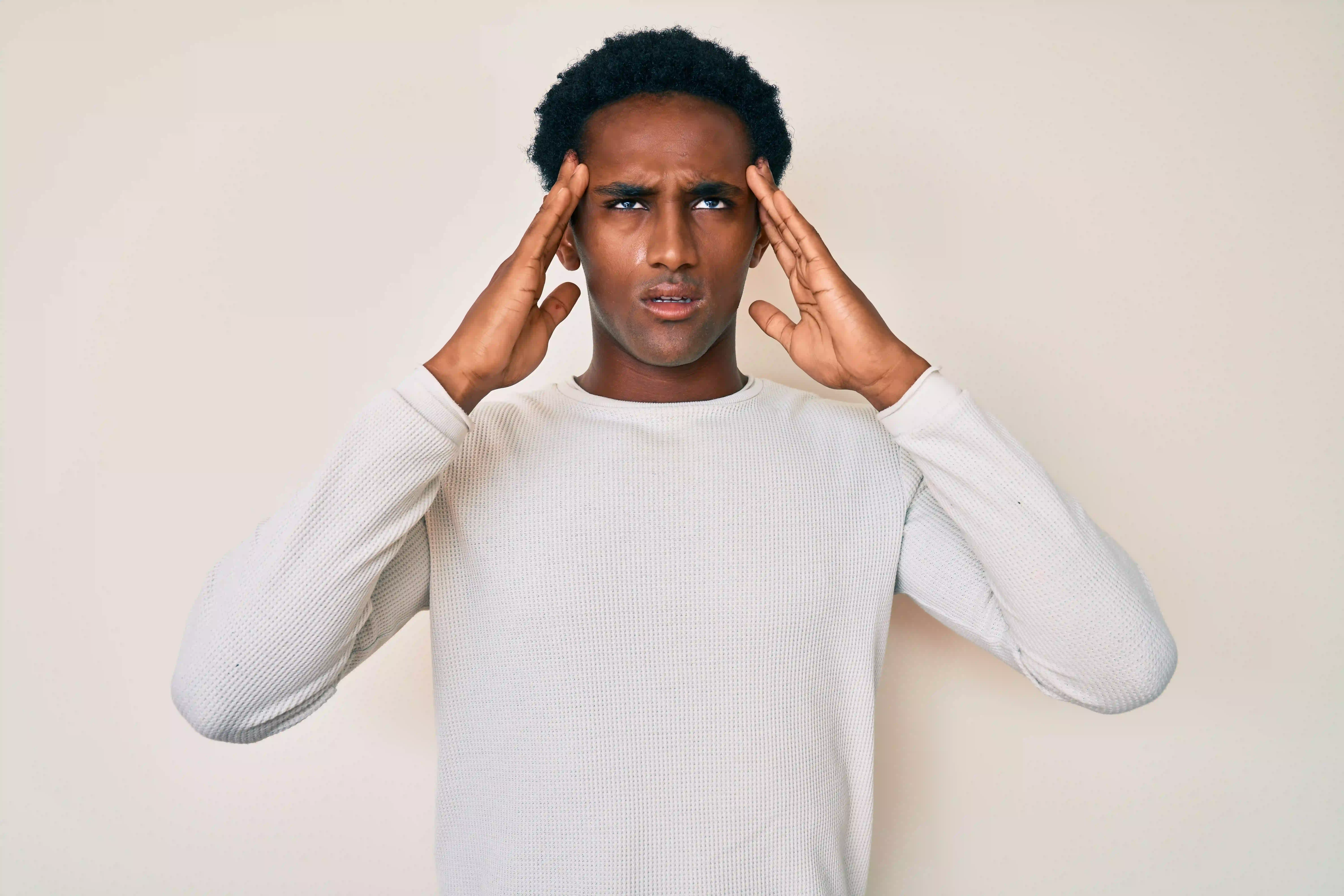 african-handsome-man-wearing-casual-winter-sweater-suffering-from-headache-desperate-stressed-because-pain-migraine-hands-head